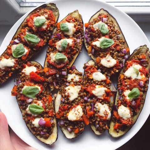 Baked Protein Eggplant Pizza Boats, steaming with aromatic herbs, perfect for a healthy dinner.