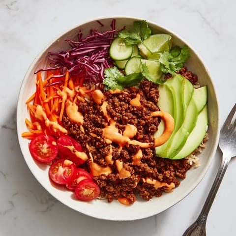 Delicious Plant-Based Meat Bowl drizzled with spicy mayo, perfect for a quick lunch.  