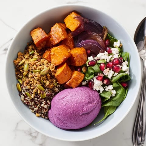 Hearty Spiced Winter Bowl topped with homemade pistachio-maple crumble and pomegranate.  