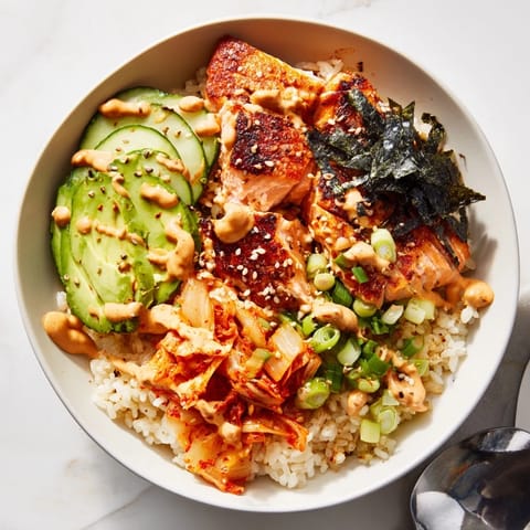 Flavorful crispy salmon rice bowl garnished with sesame seeds and garlic chips.  