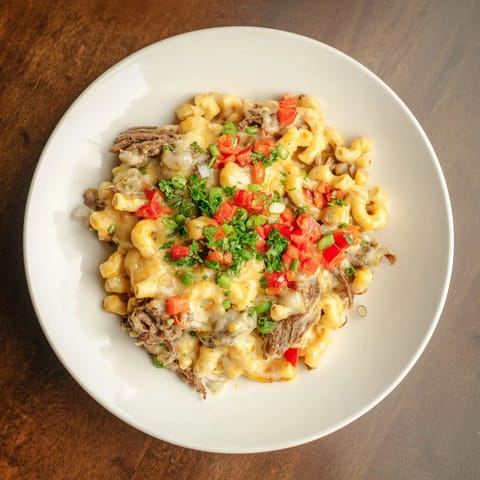 Golden-topped BBQ Rib Macaroni Skillet, featuring a blend of cheeses and flavorful rib meat, ready to serve.