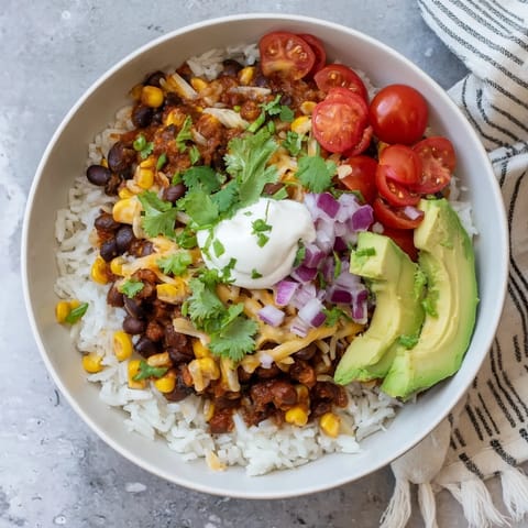 Hearty Rice, Bean, and Corn Burrito Bowls overflowing with Tex-Mex flavors, ready to eat!