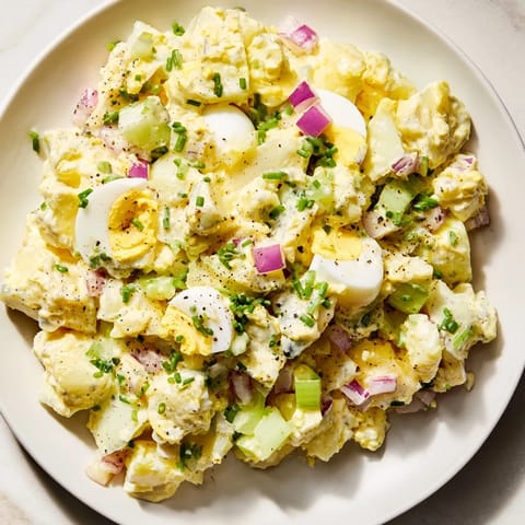 Tender potatoes and perfectly chopped eggs mingle in this classic Chopped Egg and Potato Salad, ideal for a picnic.