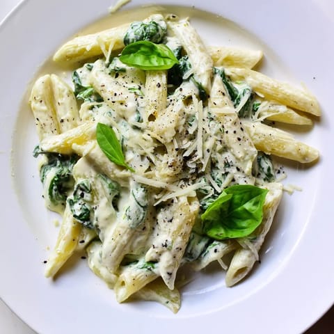 A close-up of a bowl of Cottage Cheese Creamy Spinach Pasta, fragrant and ready to eat.