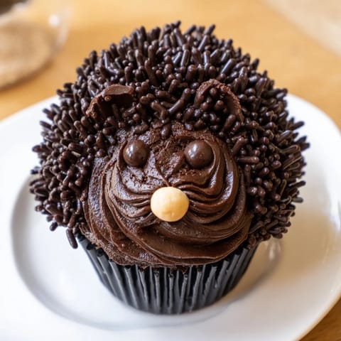 Close-up of a whimsical Hedgehog Cupcake Tower, showing each chocolate cupcake decorated with sprinkles and spiky almonds.