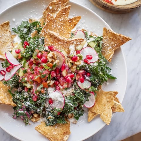 A beautiful Winter Salad with snowflake tortilla chips, boasting a colorful mix of seasonal ingredients.