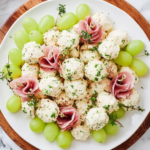 Fresh thyme and mint garnish the festive Mistletoe Kissing Ball, a delightful holiday appetizer.
