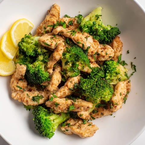 Flavorful microwave-steamed chicken and broccoli bursting with vibrant color and delicious seasoned steam.