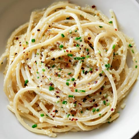 Savory Miso Butter Pasta, garnished with fresh chives, a quick and delicious weeknight meal.
