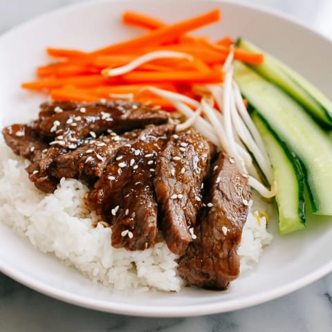 Enjoy the savory aroma of this homemade Bulgogi beef bowl featuring tender beef and fresh toppings.