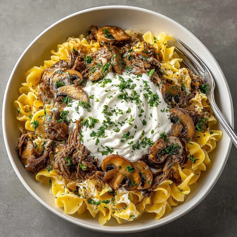 Tender shredded beef in this easy slow cooker beef stroganoff, ready to enjoy!