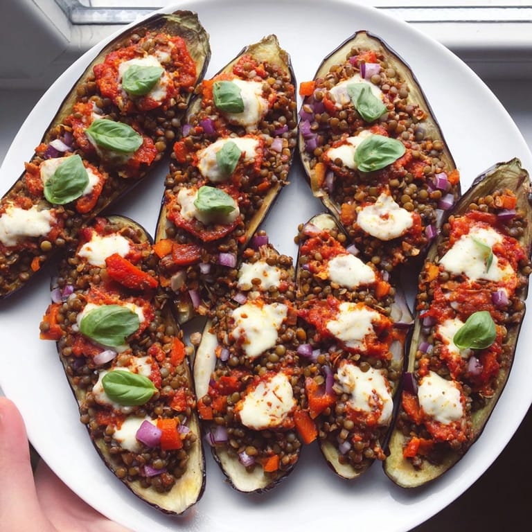 Baked Protein Eggplant Pizza Boats, steaming with aromatic herbs, perfect for a healthy dinner.