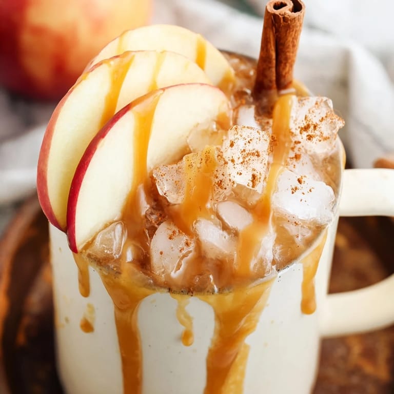 Refreshing Spicy Caramel Apple Mule served in copper mugs with caramel drizzle on top.  