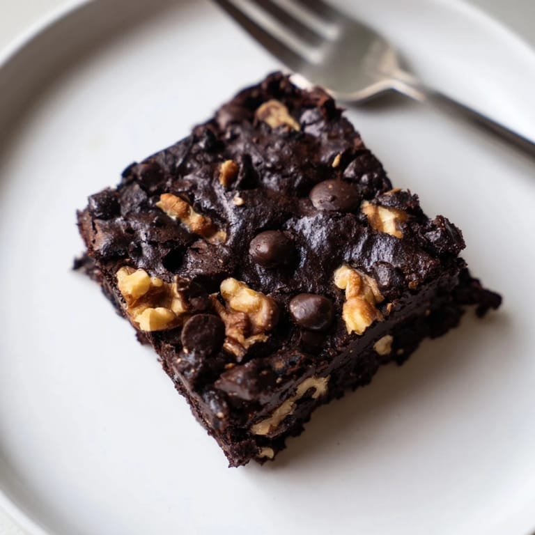 Irresistible nut-milk pulp brownies topped with chocolate chips for a guilt-free treat.
