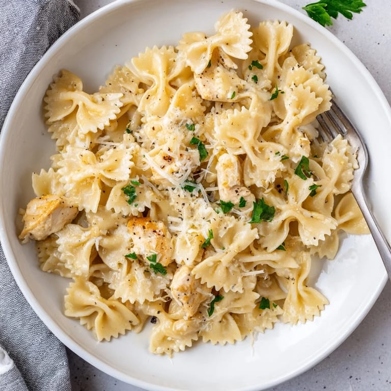 Delicious Mozzarella Garlic Butter Chicken Bowties topped with melted cheese and herbs.