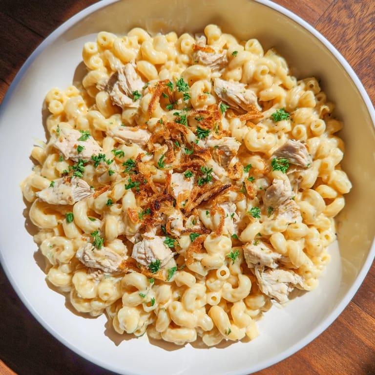 Golden, steaming One-Pot Honey BBQ Chicken Mac and Cheese, with a swirl of honey BBQ sauce, a family favorite.