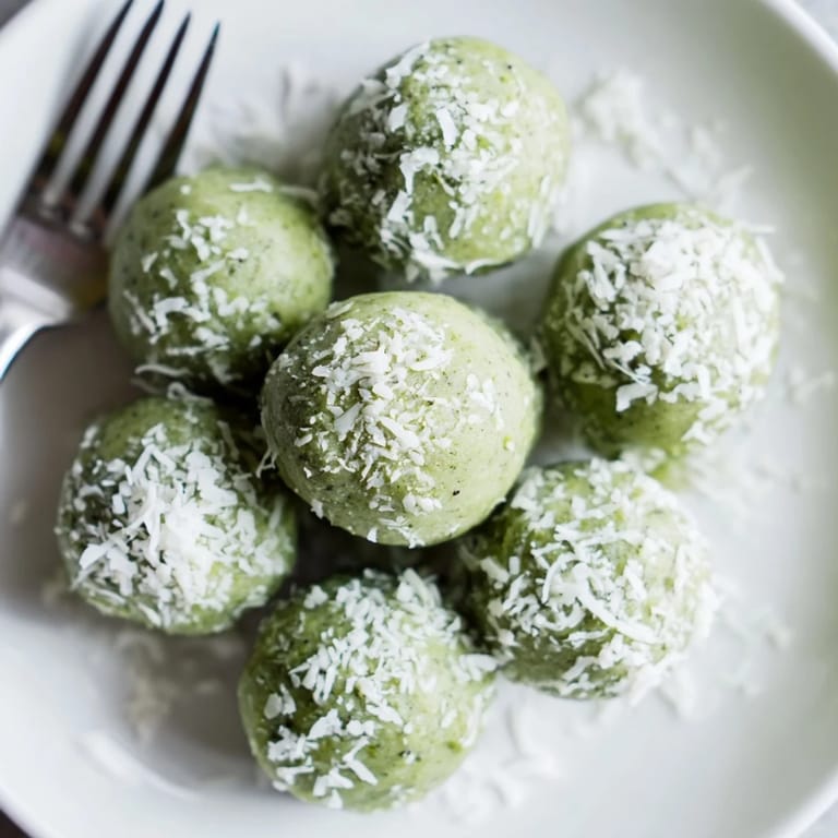 Close-up of chilled Coconut Matcha Snowball Fat Bombs, offering a delightful blend of matcha and coconut flavor.