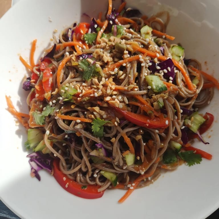 A bowl of delicious cold noodle salad, tossed with sesame-ginger sauce and fresh cilantro for a bright flavor.