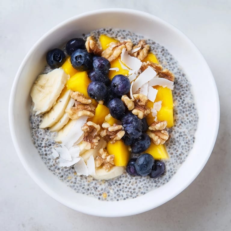 Overnight chia seed pudding, layered in a glass with colorful fruits, perfect breakfast.