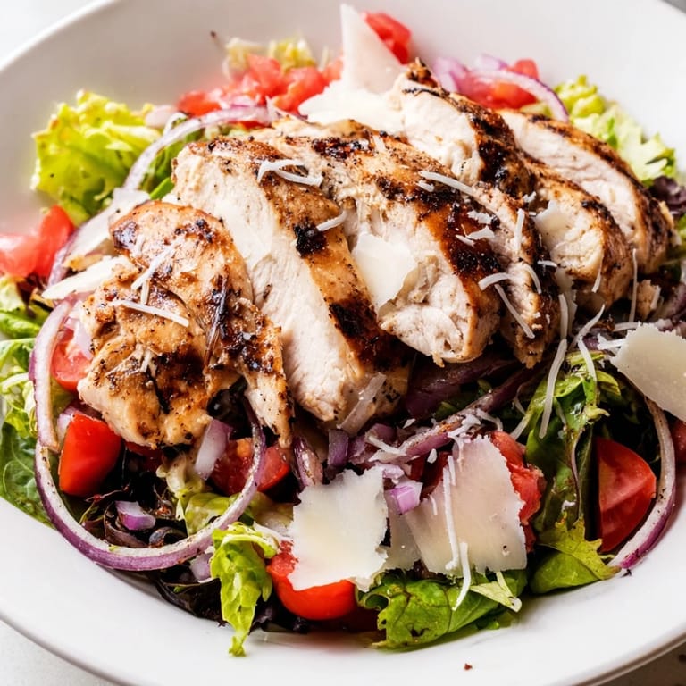 Savory Bruschetta Chicken Salad served with lemon wedges and shaved Parmesan for a light Italian-American dinner.