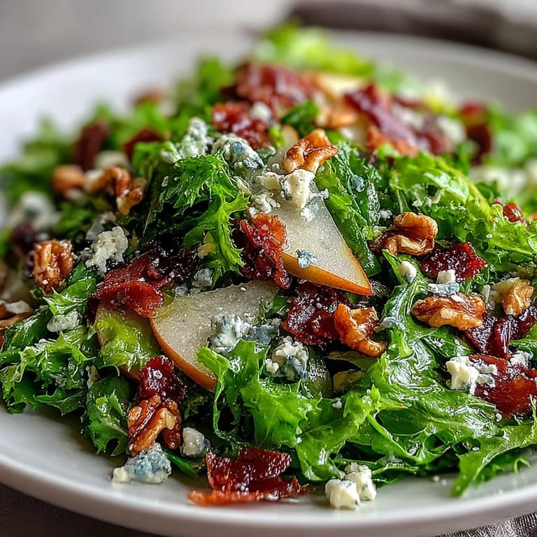 Toss this refreshing Frisée Pear Blue Cheese Bowl for a quick, elegant salad topped with crispy prosciutto and tangy vinaigrette.